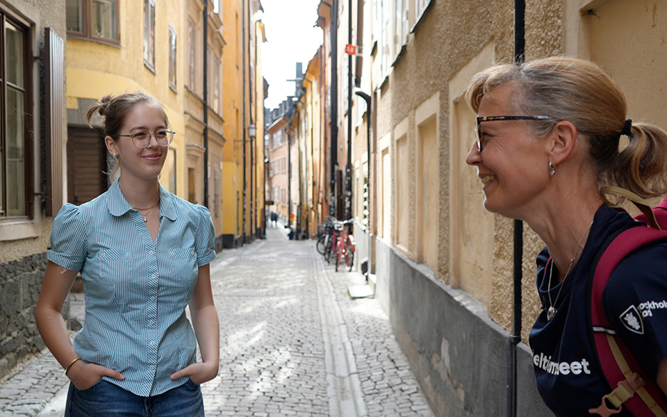 Guide with a young participant in a narrow alley.
